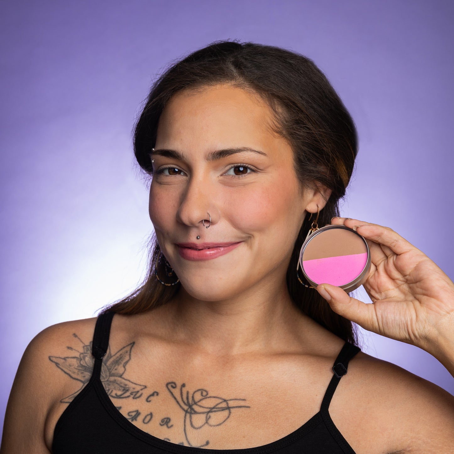 A woman wearing Cheekbone Beauty's bronzer on her cheeks.